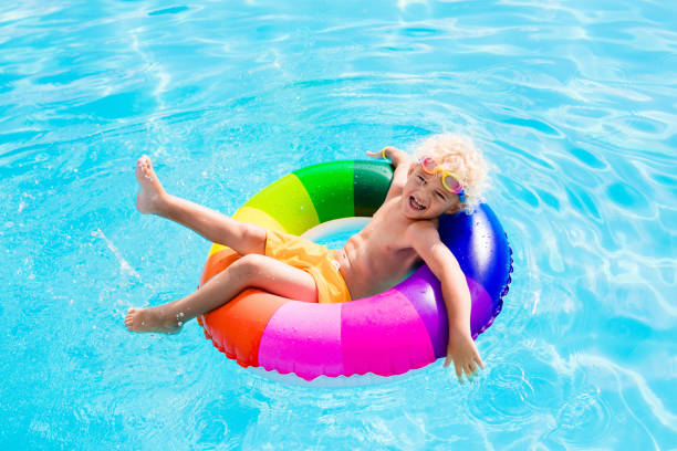 istock Child with toy ring in swimming pool 679896790