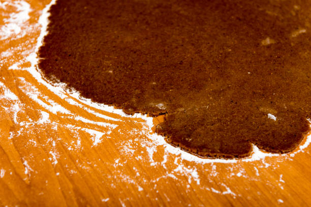 istock Making Gingerbread Cookies Series. Cutting dough sheet into shapes. 679897408