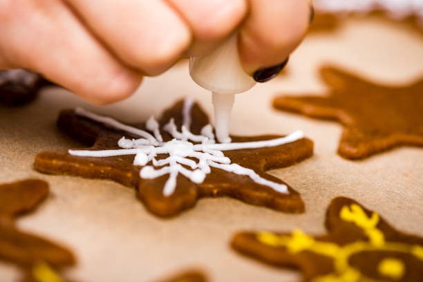 istock Making Gingerbread Cookies Series. Preparing and cutting dough sheet into shapes. 679897542