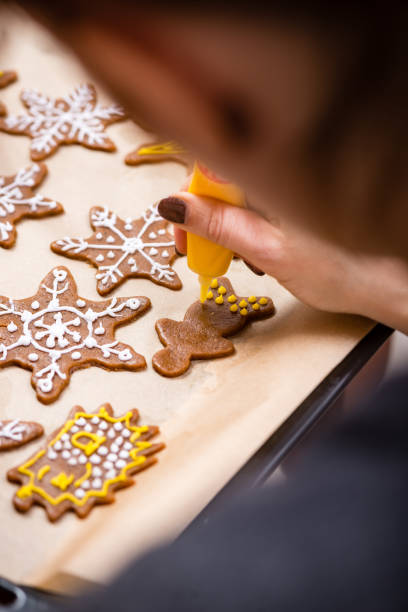 istock Making Gingerbread Cookies Series. Preparing and cutting dough sheet into shapes. 679897554
