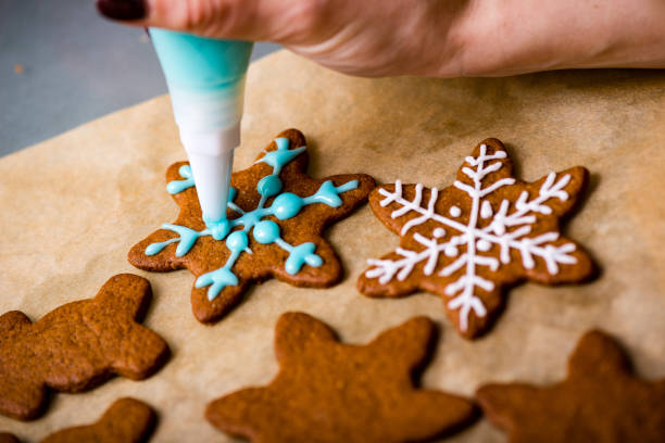 istock Making Gingerbread Cookies Series. Preparing and cutting dough sheet into shapes. 679897562