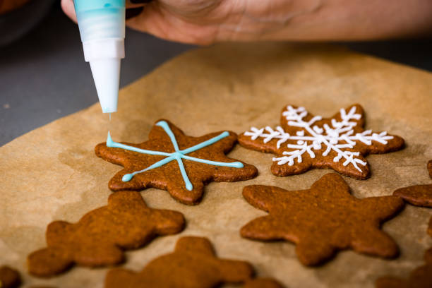 istock Making Gingerbread Cookies Series. Preparing and cutting dough sheet into shapes. 679897574