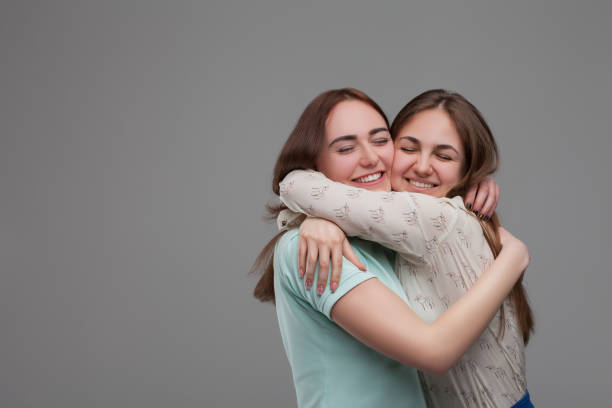 istock Two happy girlfriends hugs together 679897962