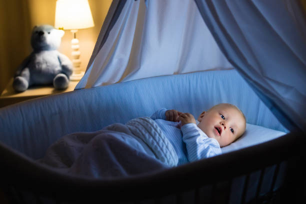 istock Baby boy drinking milk in bed 679904460