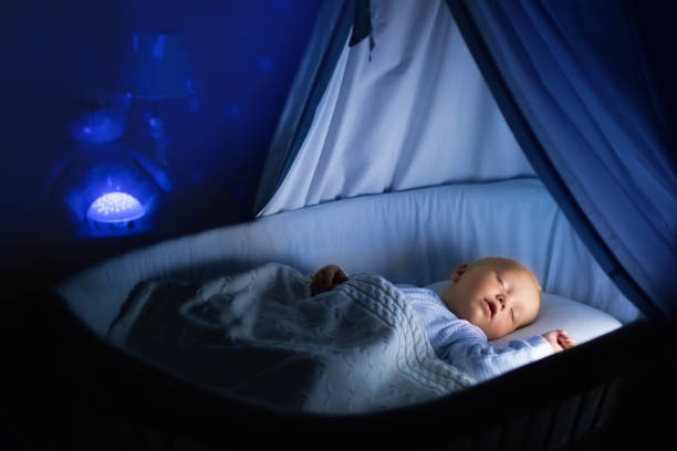 istock Baby boy drinking milk in bed 679904850