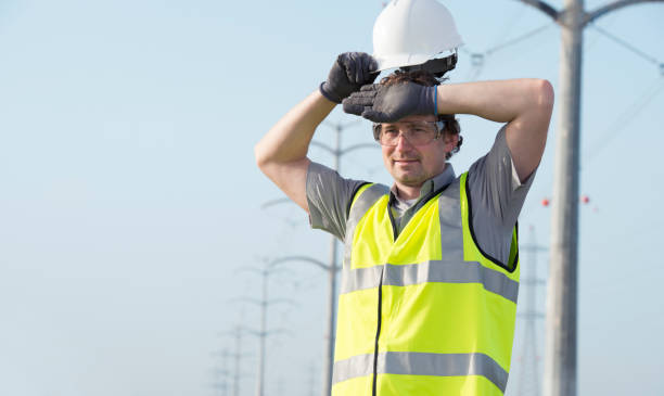 Electrician wipes his forehead. stock photo