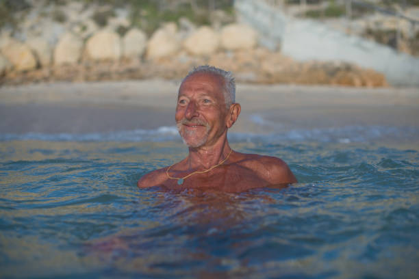 istock Handsome active senior man at the beach 679910858