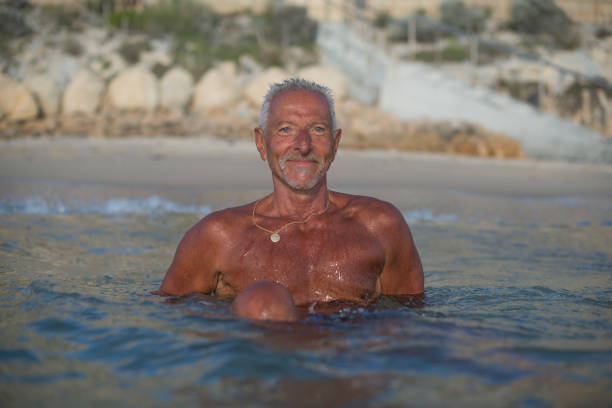 istock Handsome active senior man at the beach 679910860