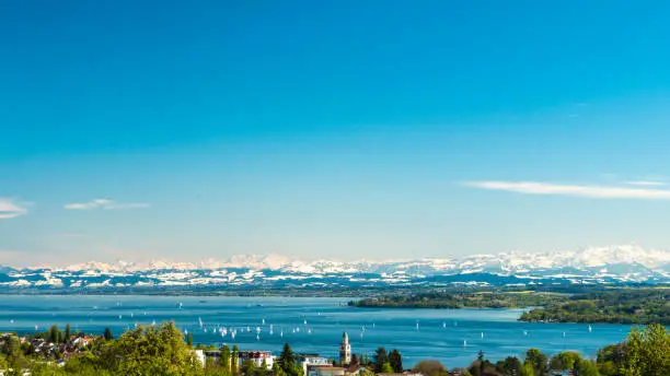 Panoramic view of lake of Lake Constance with Swiss Alps in background
