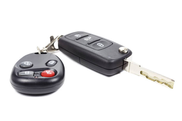 istock Ignition key and garage door remote control on a white background 679916282