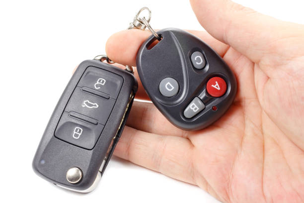 istock Man holds in hand ignition key and garage door remote control 679916288