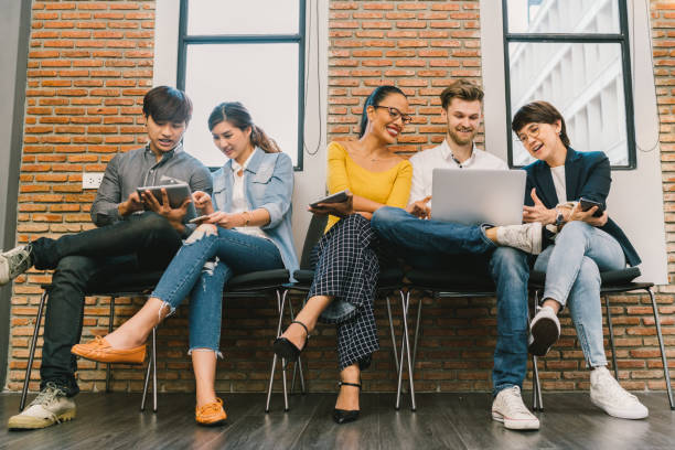 istock Multiethnic diverse group of young and adult people using smartphone, laptop computer, digital tablet together. Modern lifestyle with information technology gadget, education, social network concept 679916670