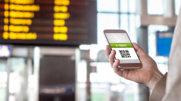 istock Buying online ticket from internet. E-ticket on mobile phone screen with schedule in the blurred background. Universal public transportation terminal. Bus, train, metro, subway or underground station 679923750