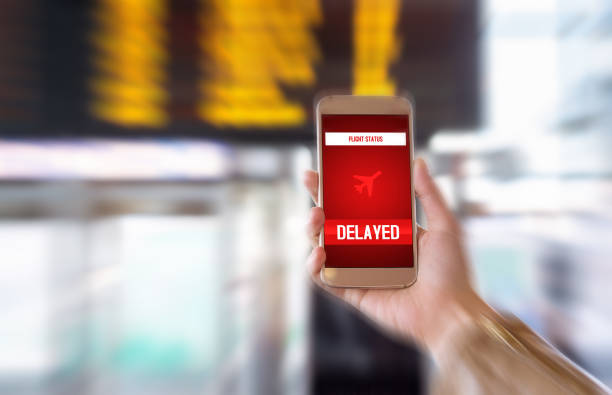 istock Flight delayed. Delay in flying schedule. Aeroplane will take off late. Smartphone application announces bad news to tourist. Woman holding mobile phone in airport terminal. Timetable background. 679923800