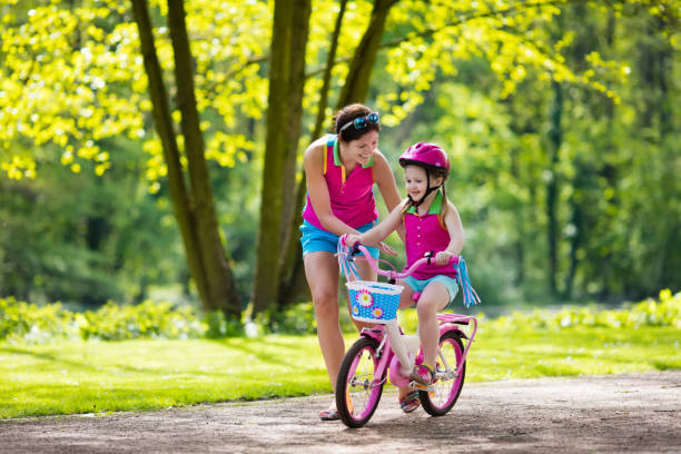 istock Mother teaching child to ride a bike 679924400