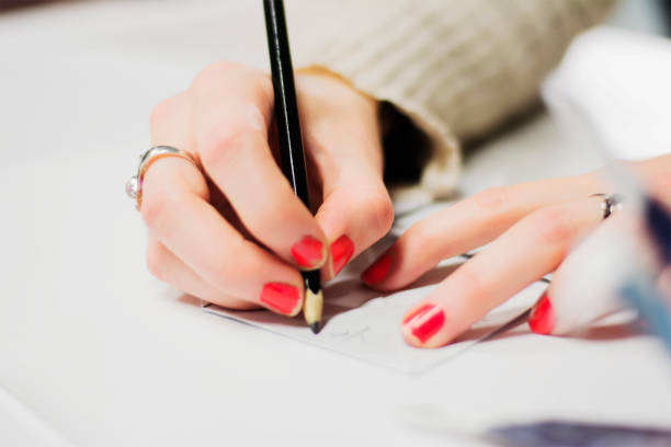istock Girl Writing on a Cootie Catcher 679927254