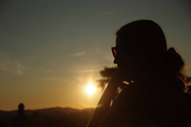 istock Woman is watching the sunset 679938936