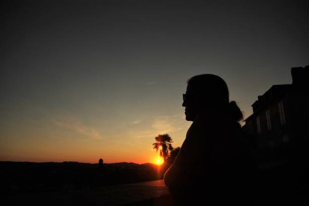 istock Woman is watching the sunset 679938956