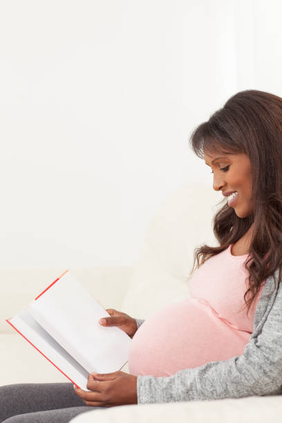 istock Relaxed pregnant woman reading a book. 679939148