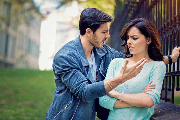 young couple is arguing on the street - beautiful female displeased furious imagens e fotografias de stock