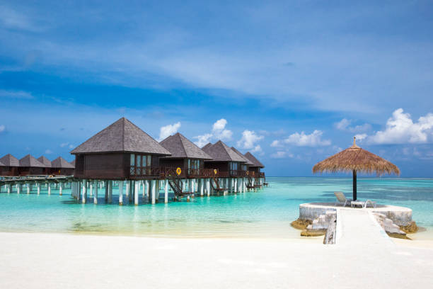 istock beach with water bungalows at Maldives 679940002