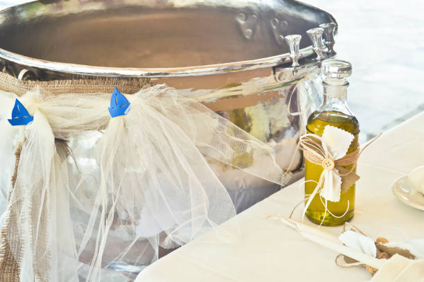 greek Orthodox christening decoration with baptism oil, candles and the greek kolimbithra