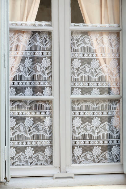 istock The white window with decorative old lace curtains 679950318