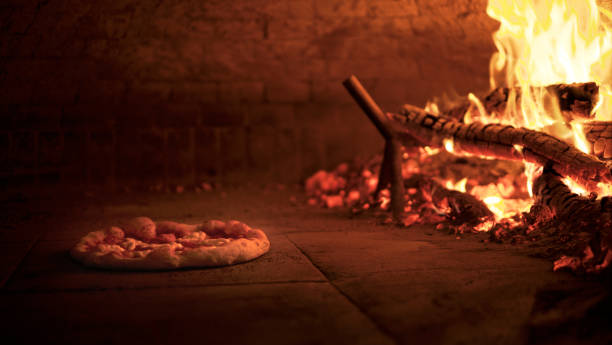 Pizza, cooking in a wood-fired oven