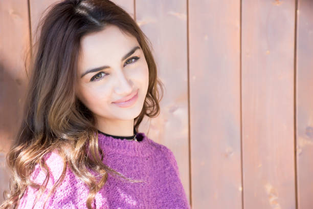 istock Young smiling woman and wooden background 679959792