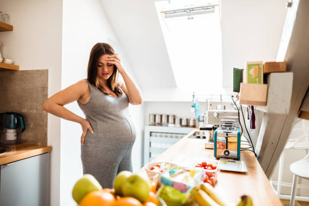 istock pregnant woman resting in the kitchen 679960108