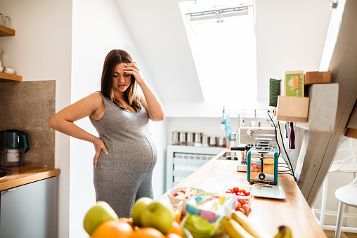 pregnant woman resting in the kitchen