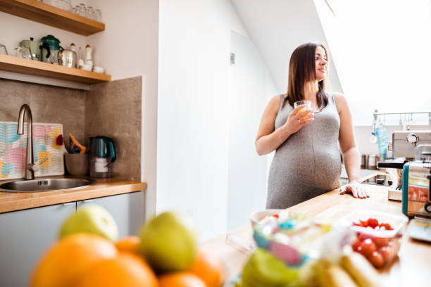 istock pregnant woman resting in the kitchen 679960126