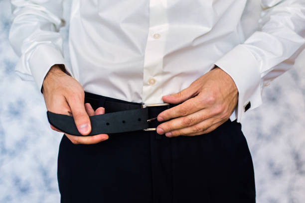 istock man corrects belt, fees groom, man's hands, dressing 679966274