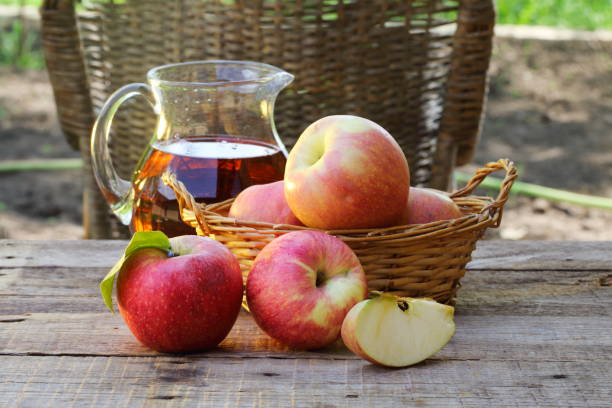 istock red apples on wooden table outdoor 679967686
