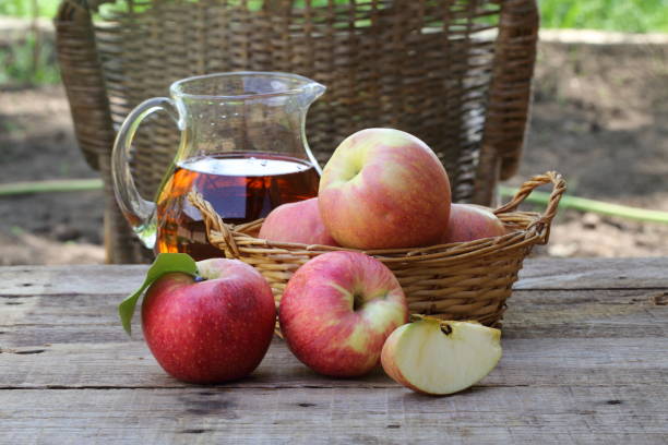 istock red apples on wooden table outdoor 679967688