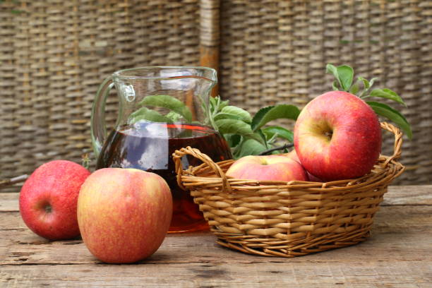 istock red apples on wooden table outdoor 679967720