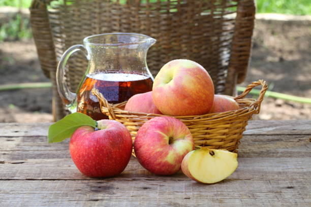 istock red apples on wooden table outdoor 679967746