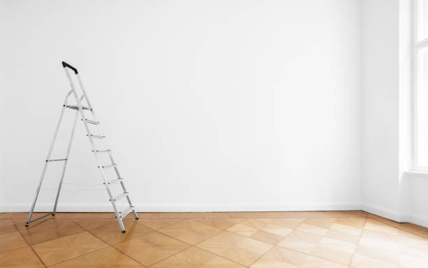istock ladder in empty room with white wall and wooden floor 679968118
