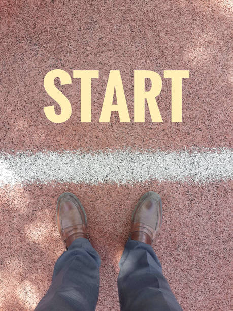 istock Start business concept feet on the pavement inscription feature line 679972636