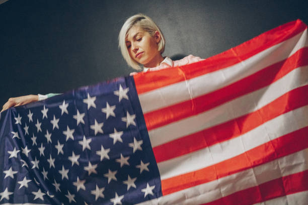 istock Blonde girl with USA flag 679975276