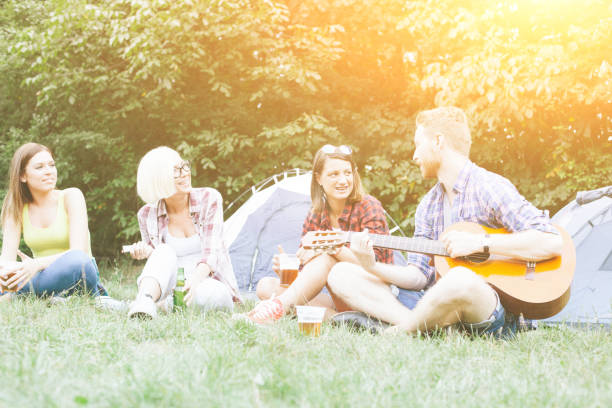 istock Man and three women on camping in nature 679975302