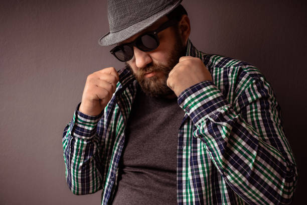 istock Handsome hipster bearded man with hat,sunglasses and shirt hold collar. 679976588