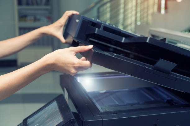 istock woman opening a copying device 679976618