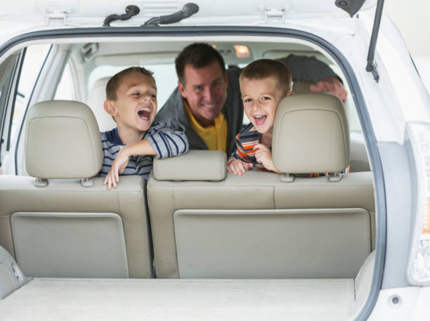 istock Father and two little boys inside car 679978682