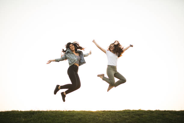 istock Happy jumping young two womans 679978750