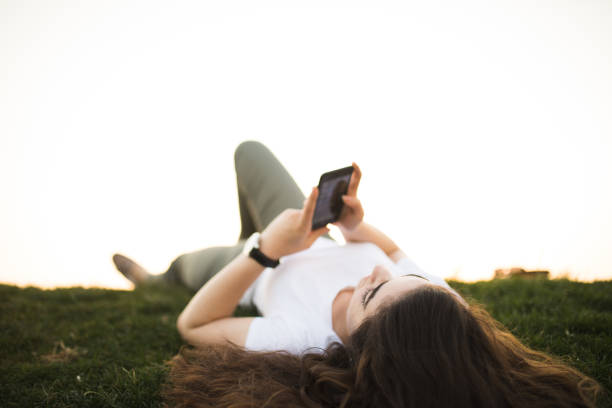 istock Young woman relaxing and using smart phone 679978790