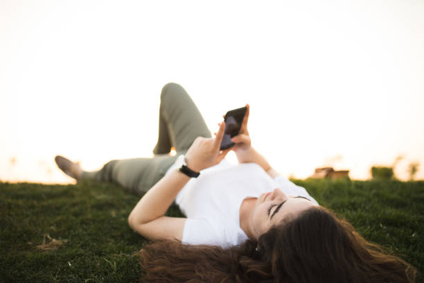 istock Young woman relaxing and using smart phone 679978914