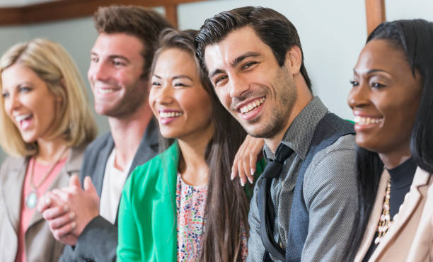 istock Multi-ethnic group of men, women watching presentation 679983732
