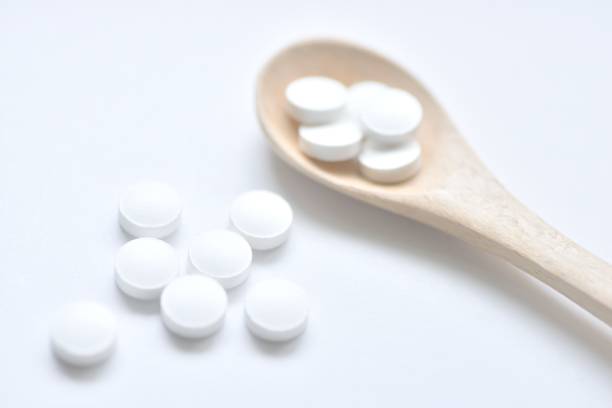 istock White supplement pills on wooden spoon 679990448