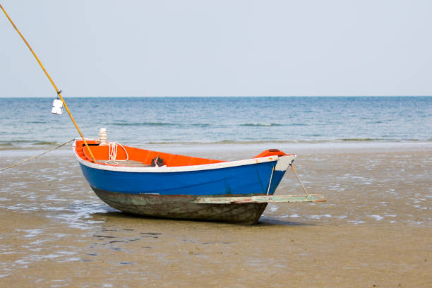 istock Image of small boat sitting on the beach. 679990850